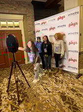 pet-care pros taking selfies with the Gingr photo backdrop 
