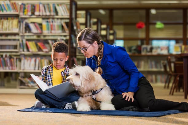 boy reading to a dog at library