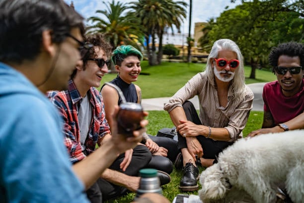 buddies at a dog park or bar admiring a cute pup