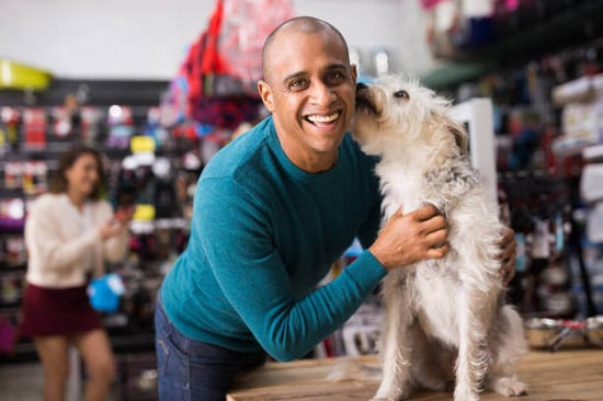 Happy pet parent inside pet supplies store