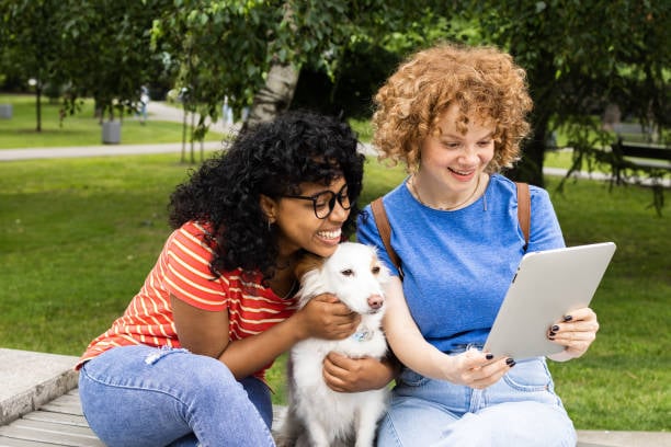 pet parents looking at ipad with dog