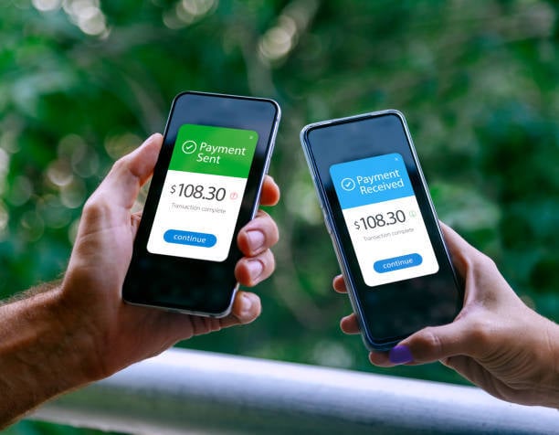 business owner and customer comparing phones to see payment sent and received