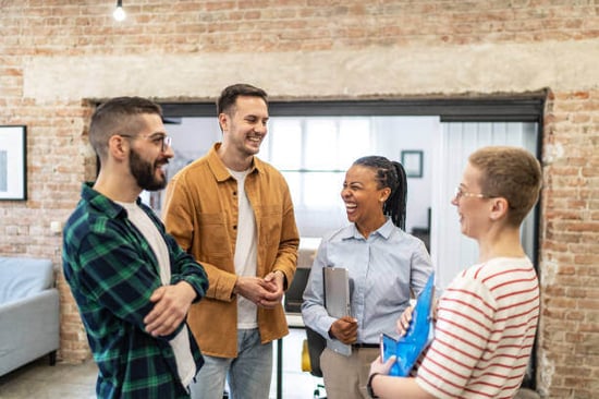 A group of people stand together talking
