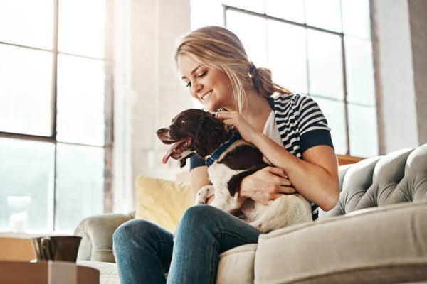 A woman pets a dog