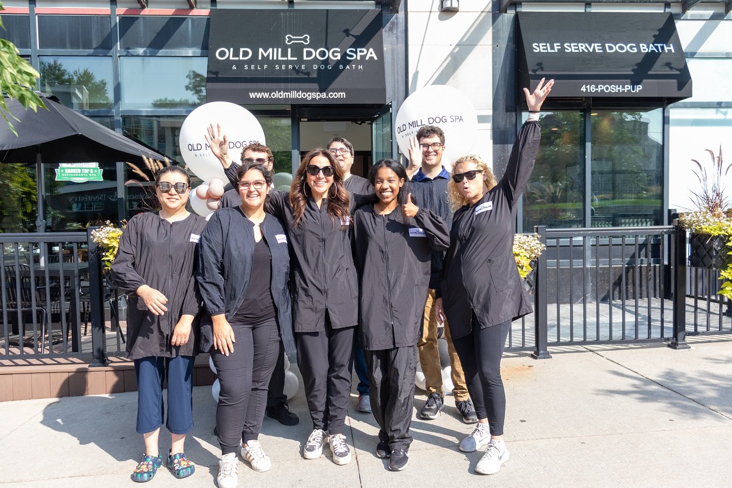 Old Mill Dog Spa pet grooming team stands outside of their business in Toronto