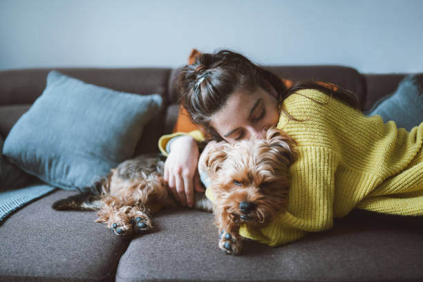 A woman hugs a dog