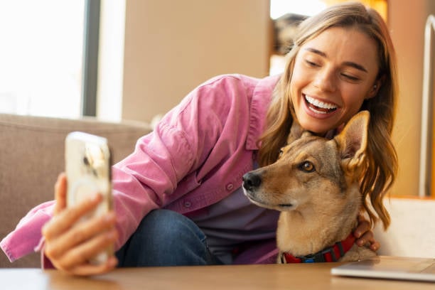 influencer taking a selfie with a cute pup