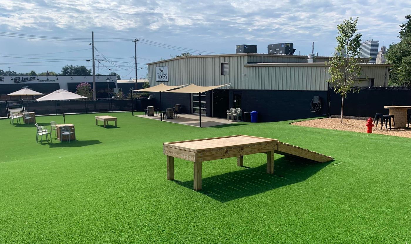 The dog bar and off-leash yard at Tucker's Tap Yard, a Gingr dog park in Winston-Salem, North Carolina